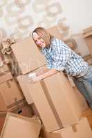 Moving house: Woman with box in new home
