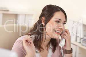 Portrait of young businesswoman on phone at office