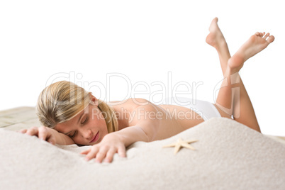 Beach - woman with starfish lying in sand