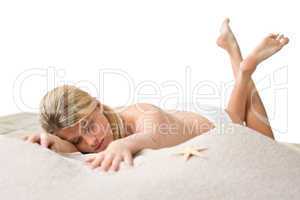 Beach - woman with starfish lying in sand