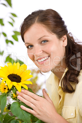 Portrait of happy woman with sunflower