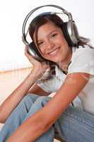 Smiling teenager with headphones listening to music