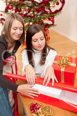 Two woman packing Christmas present