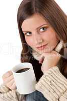 Winter portrait of happy woman holding cup of coffee