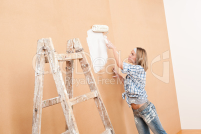 Home improvement: Woman painting wall