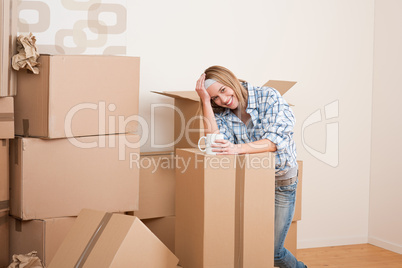 Moving house: Woman with box in new home