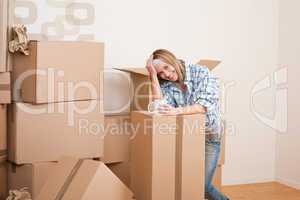 Moving house: Woman with box in new home