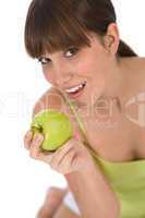 Happy female teenager with healthy apple