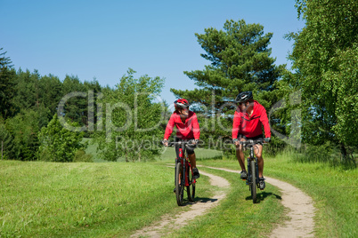 Young couple with mountine bike in spring nature