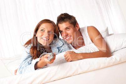 Young man and woman lying down in lounge