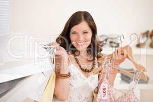 Fashion shopping - Happy woman choose sale clothes