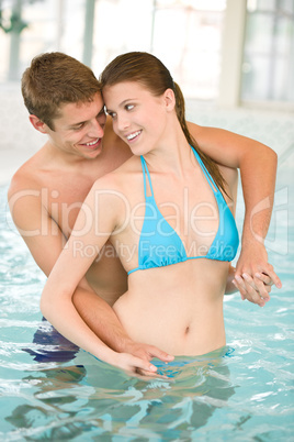 Swimming pool - young playful couple have fun