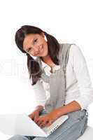 Smiling teenager sitting with laptop