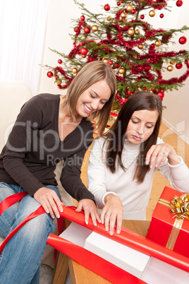 Two woman packing Christmas present