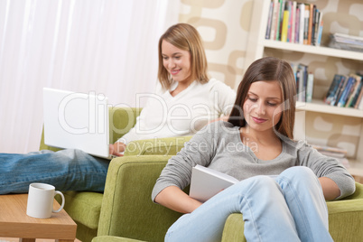 Students - Two teenage girls with laptop and book