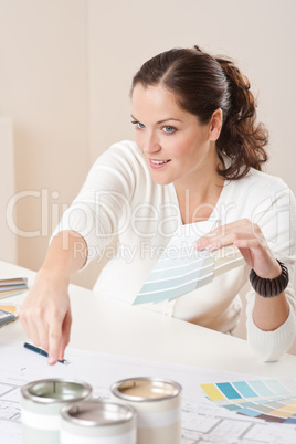 Young female interior designer working at office