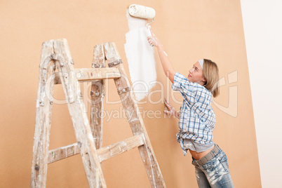 Home improvement: Woman painting wall