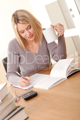 Student series - Blond girl writing homework