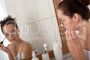 Body care series - Young woman applying mascara