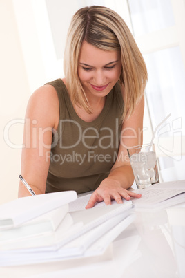 Student series - Young blond woman writing