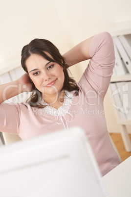 Young businesswoman watching computer screen