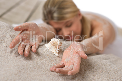 Beach - woman with shell lying in sand Beach - woman with shell lying in sand