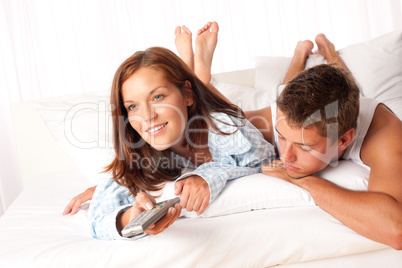 Young man and woman lying down in lounge