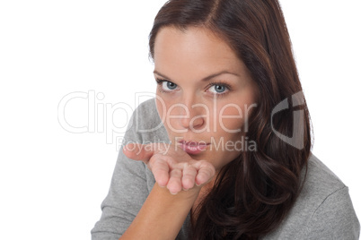 Happy young woman blowing a kiss