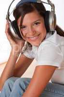 Smiling teenager with headphones listening to music