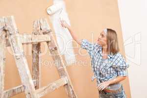 Home improvement: Woman painting wall