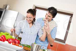 Smiling couple cook in modern kitchen