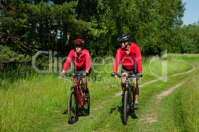 Young couple with mountine bike in spring nature