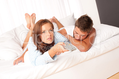 Young man and woman lying down in lounge