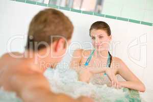 Spa - young loving couple enjoy hot tub
