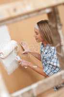 Home improvement: Woman painting wall