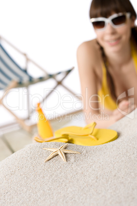 Beach - starfish on sand, woman in bikini in background