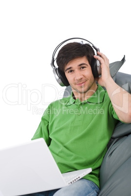 Young man with laptop and headphones