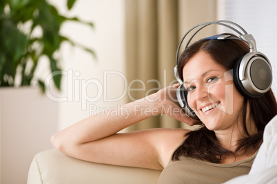 Woman with headphones listen to music  in lounge