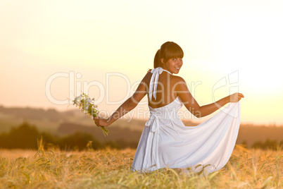 Romantic woman in sunset corn field wear dress