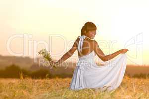 Romantic woman in sunset corn field wear dress