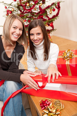 Two women packing Christmas present