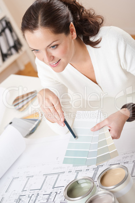 Young female interior designer working at office