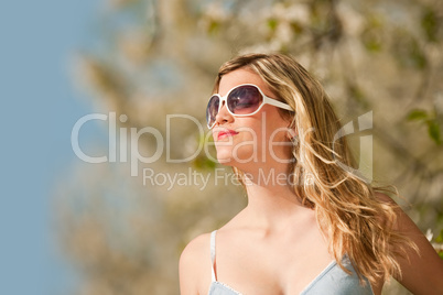 Spring - Young woman under blossom tree enjoy sun