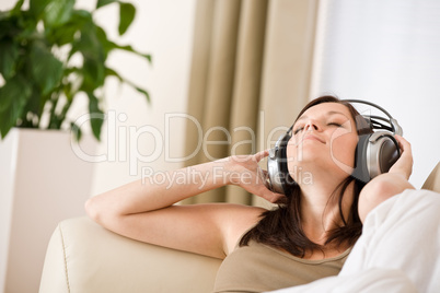 Smiling woman with headphones listen to music