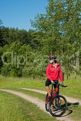 Young woman with mountain bike in the nature