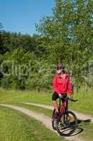 Young woman with mountain bike in the nature