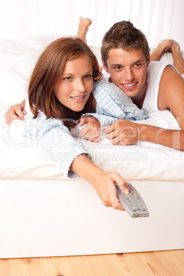 Young man and woman lying down in lounge