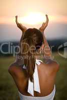 Young brunette woman in sunset