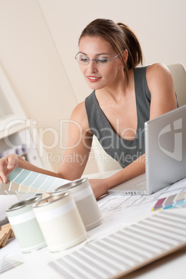 Young female designer working at office with laptop