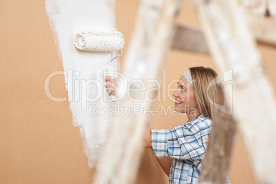 Home improvement: Woman painting wall